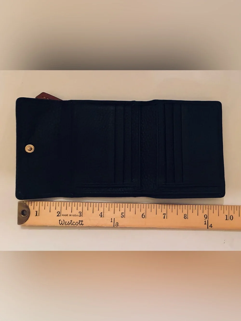 Dooney & Bourke Black Pebbled Leather Wallet with Brown Trim and Gold Plaque